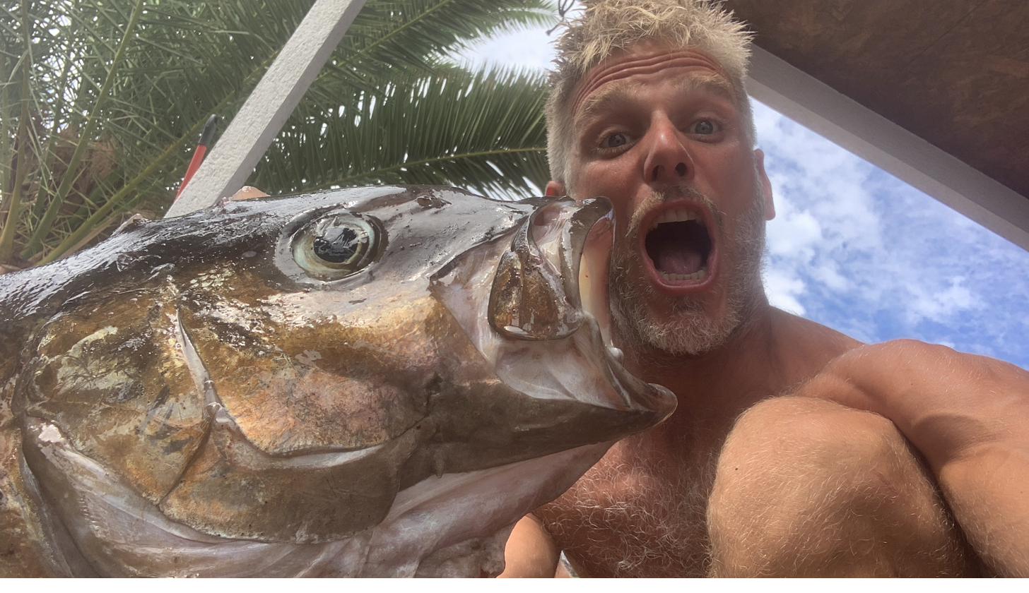 Hunter face-to-face with giant amberjack